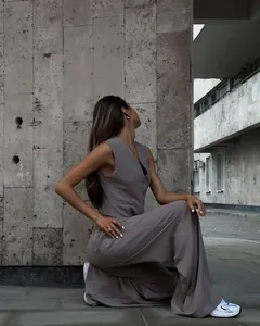 Two-piece mauve suit set featuring a tailored V-neck vest and flowy wide-leg trousers.