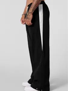 Fashionable men's loose black casual pants with white side stripes and drawstring