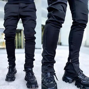 Detail of black slim-fit joggers for men featuring a zippered hem and elastic fabric.