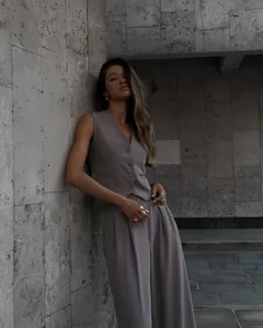 Professional view of a chic women's taupe V-neck vest and wide-leg trouser set