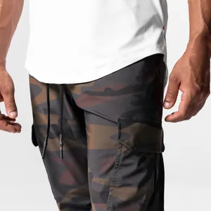 Detailed close-up of men's camouflage cargo pants with side pockets and drawstrings