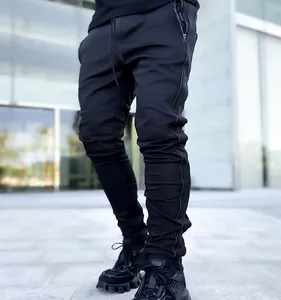 Detail view of men's black reflective joggers with functional side zipper pocket.