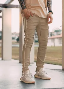 Close-up detail of khaki slim fit cargo pants with reflective side stripes for men
