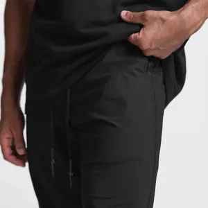 Close-up of black men's ice silk gym joggers showing fabric texture and side pocket