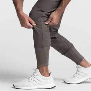 Close-up detail of men's brown stretch athletic joggers fabric and ribbed ankle cuff design