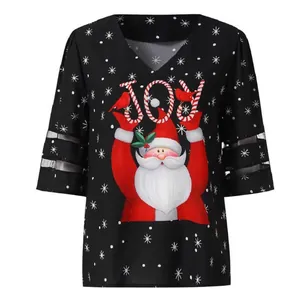 Close-up of Santa Claus print and mesh patchwork on bell sleeves of Christmas top.