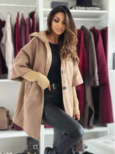 Detail of stylish khaki hooded wool coat with large buttons in a closet setting