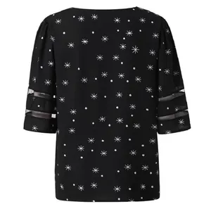 Detailed back view of a black women's festive star print top featuring mesh bell sleeves