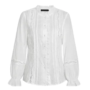 Detailed view of elegant white cotton blouse with ruffle collar and pearl buttoning