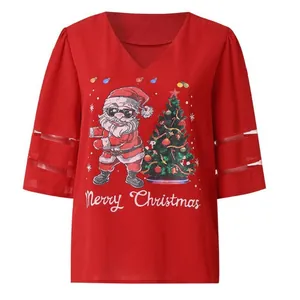 Close-up of women's red Christmas top with mesh sleeves and Santa Claus print