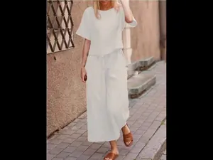 Casual white two-piece set with loose short-sleeved top and wide-leg trousers outfit.