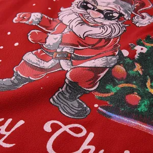 Close-up of festive Santa Claus print on red mesh Christmas blouse