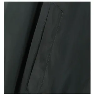 Close-up macro view showing the pocket detail and fine stitching on a dark casual jacket