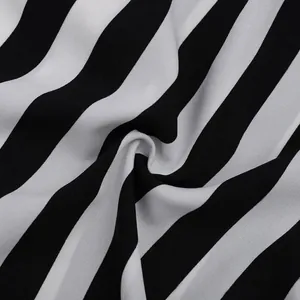 Close-up detail of soft black and white striped chiffon fabric with elegant draped texture
