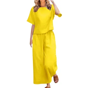 Close-up detail of a bright yellow two-piece casual summer set featuring wide-leg trousers