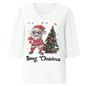 Detailed view of Santa Claus print on white V-neck top with mesh patchwork sleeves.