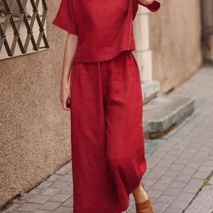 Outdoor street style view of a fashionable red loose linen two-piece set on a model