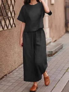 Elegant black two-piece linen-style casual set with loose top and wide-leg trousers