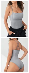Detail view showing front and cross-back straps of grey seamless knitted yoga bodysuit