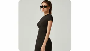 Close-up view of a tight-fitting athletic short-sleeve yoga top in black coffee color
