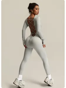Back view of a grey seamless ribbed yoga bodysuit featuring a lace-up open back design