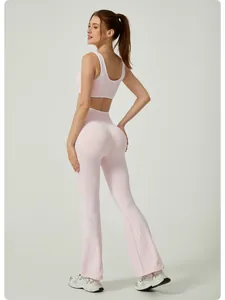 Rear view of a pink high-waisted yoga set featuring flared leggings and contrast trim.