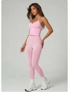 Detail view of pink halter neck yoga top and matching high-waisted fitness leggings.