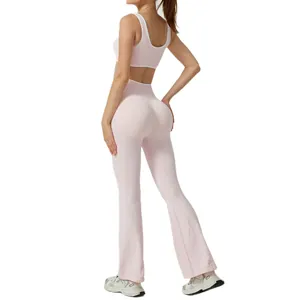 Two-piece pink yoga set with contrast trim sports bra and high-waisted flared pants