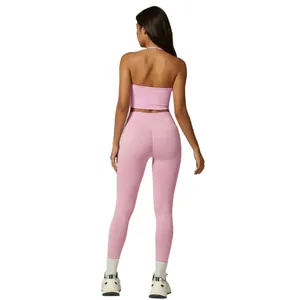 Back view of pink halter backless yoga set with high waist leggings and sports sneakers