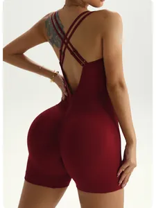 Detailed close-up of wine red ribbed yoga romper featuring double cross back straps