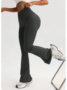 Detail shot of high waist dark grey flare yoga pants with peach lift design.