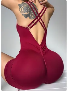 Detailed back view of a burgundy ribbed yoga jumpsuit featuring criss-cross shoulder straps