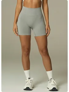 Front view of grey high-waisted seamless compression yoga shorts on a fitness model