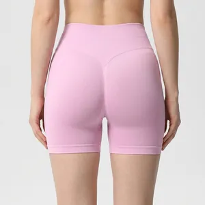 Back view of pink seamless high waist scrunch butt lifting yoga shorts for fitness.