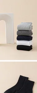 Stack of colorful 100% cotton ribbed men's mid-calf socks with double-needle detail