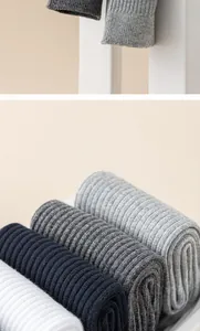 Detailed view of vertically ribbed men's crew socks in various neutral colors