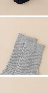 Close-up of gray ribbed men's mid-calf socks highlighting the elastic knit texture.
