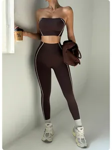 Close-up view of chocolate seamless yoga set with white contrast piping on a female model