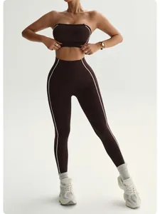 Two-piece seamless brown yoga set with white contrast piping and high-waisted leggings