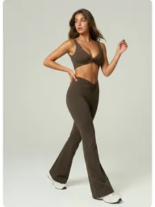 Detail of brown yoga set featuring a twisted sports bra and high-waist flared pants