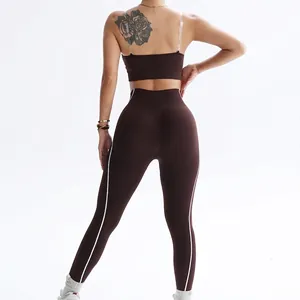 Brown seamless yoga set with tube top and high waist leggings featuring white stripes