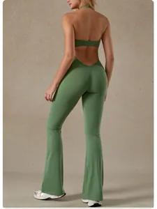 Back view of a sage green halter-neck backless yoga jumpsuit with flared legs