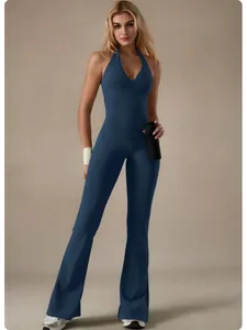 Professional detail shot of a navy blue lace V-neck yoga jumpsuit with flared leg design