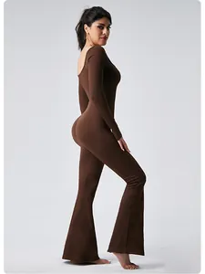 Professional side profile view of a brown long sleeve flare yoga jumpsuit for fitness