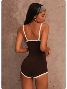 Back detail view of brown quick-dry yoga camisole with white piping and matching shorts.