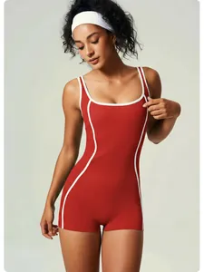 Close-up detail of a red quick-dry yoga bodysuit featuring white contrast piping and slim fit design