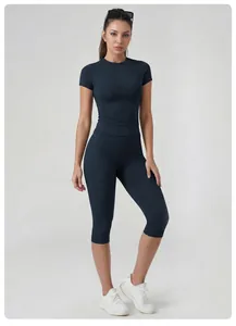 Front view of woman wearing quick-dry yoga set with short-sleeve top and capri pants