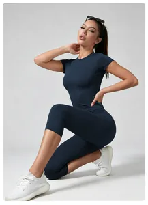 Professional navy blue yoga set with high waist leggings and short sleeve top on model