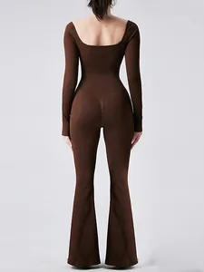 Brown long sleeve one-piece yoga bodysuit with flared leggings and stylish open back