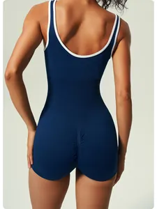 Back view of a navy blue yoga jumpsuit with white contrast trim and scrunch butt detail